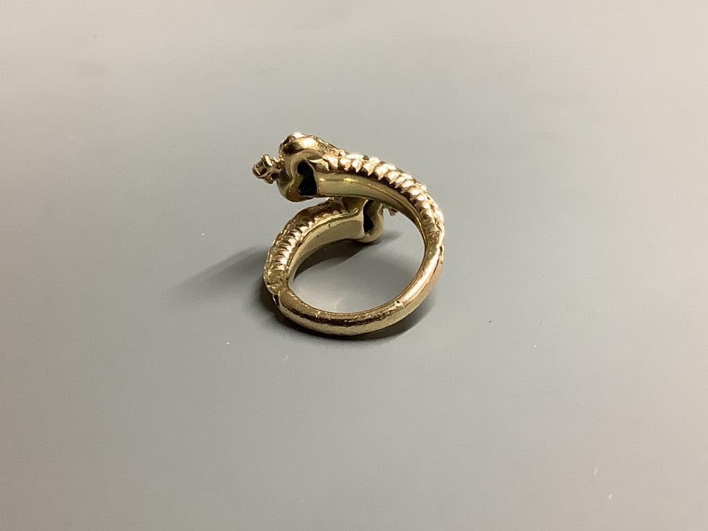 A modern yellow metal, two stone heart shaped malachite and two stone diamond set crossover ring, size F/G, gross 3.9 grams.